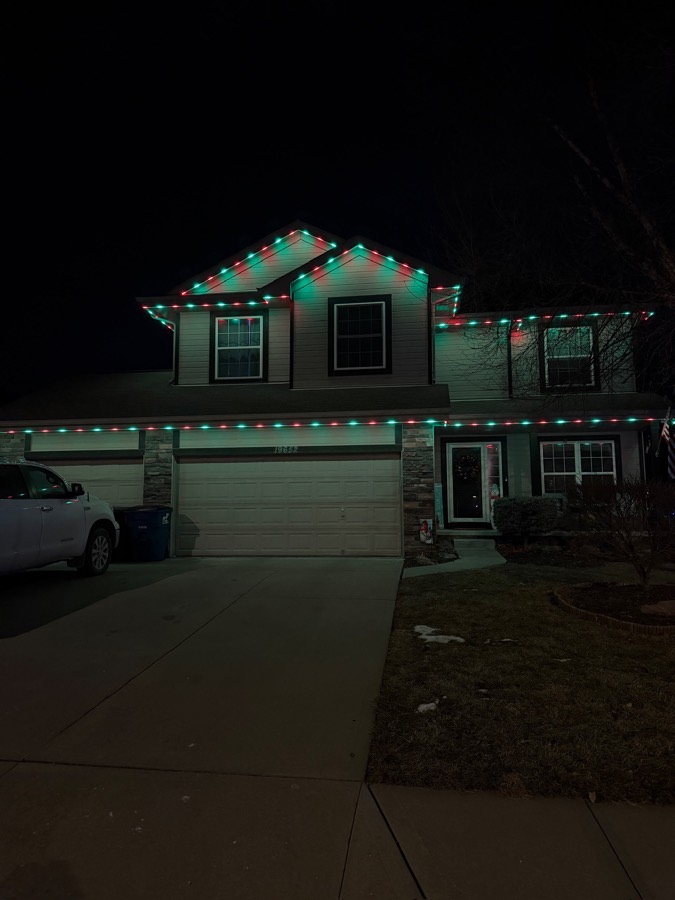 Home lit in red and green for the holidays